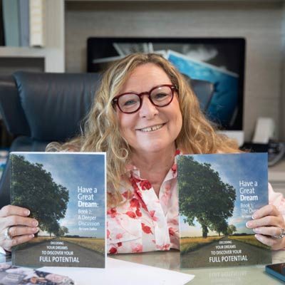 Layne Dalfen holding up her books